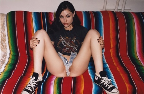 With her hairy tits on display, Sasha Grey, the slim model from London, exposes some of her shorts while wearing them to show off her locks.