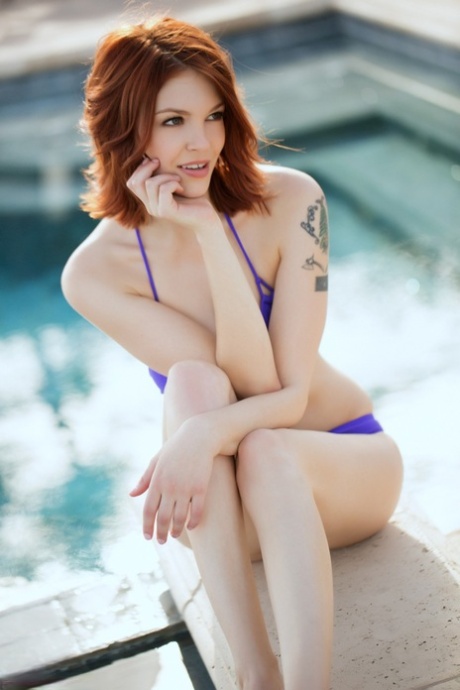 During a swim in the pool, Bree Daniels, a redhead model, gets drenched and takes off her bikini.