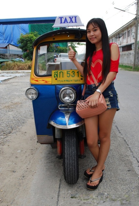 A lovely Asian girl dressed in sexy jean shorts is caught on the street.