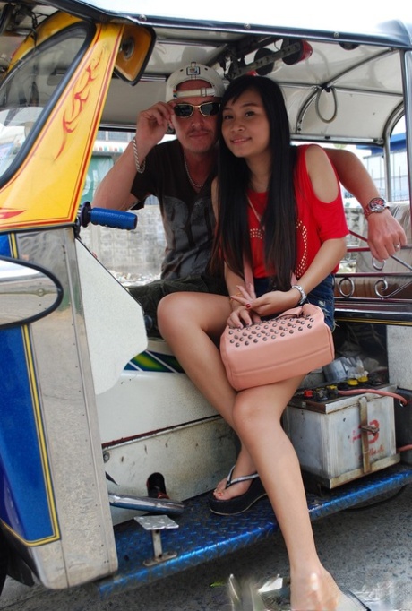 Street vendors stumble upon an attractive Asian girl dressed in flowing jean shorts.