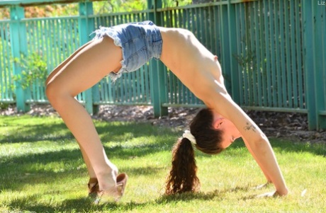 An adorable lad with a full-figured bite, Liz exhibits her small buttocks in the back yard.