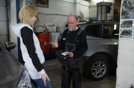 In the garage, Daniela C engages in a sexual act with an elderly man while being tall, skinny, and having a big booty.