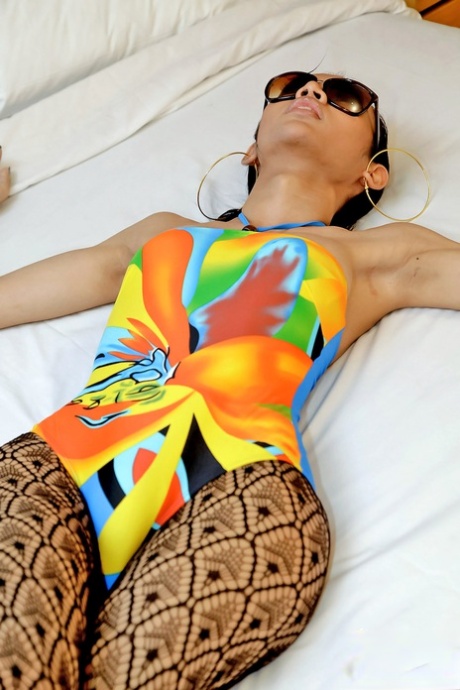 This attractive ladyboy has been losing her colorful bodysuit and masturbating while avoiding clothes.