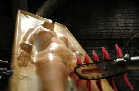 Torch-beating Christina Carter, she is strapped tightly to a vacu-bed that showcases her curves.