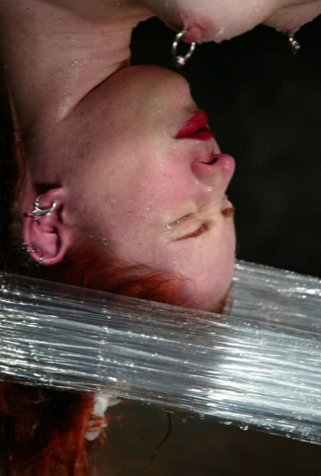 In this brutal water bondage action, Redheaded American Calico is caned and hosed off.