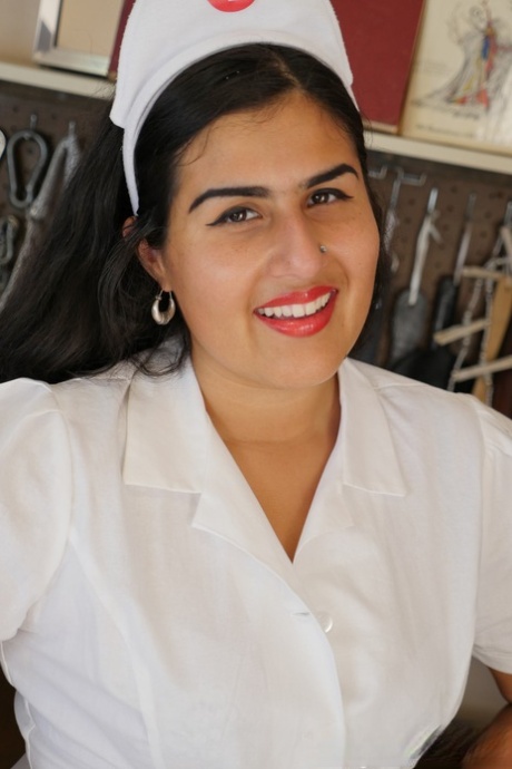Miel, the mischievous and curvy nurse, performs a solo striptease to show off her hair.