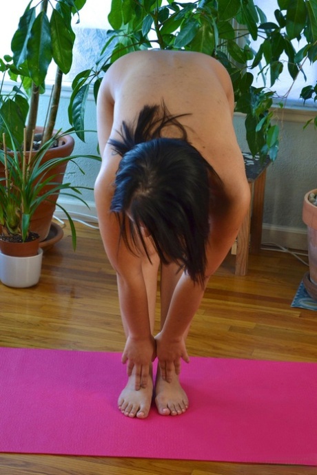 With ease, Asia stretches her body on a yoga mat and rubs hands with her balding partner.