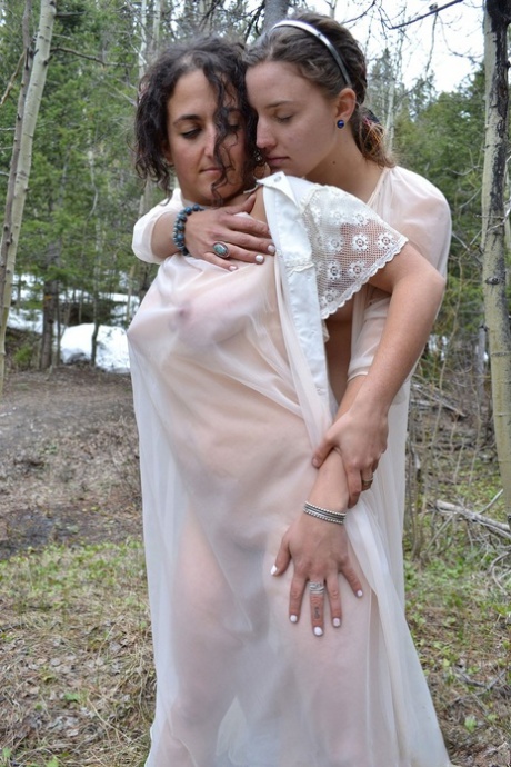 Sage and Simona, both naturally beautiful girls, snuggle up in the woods.