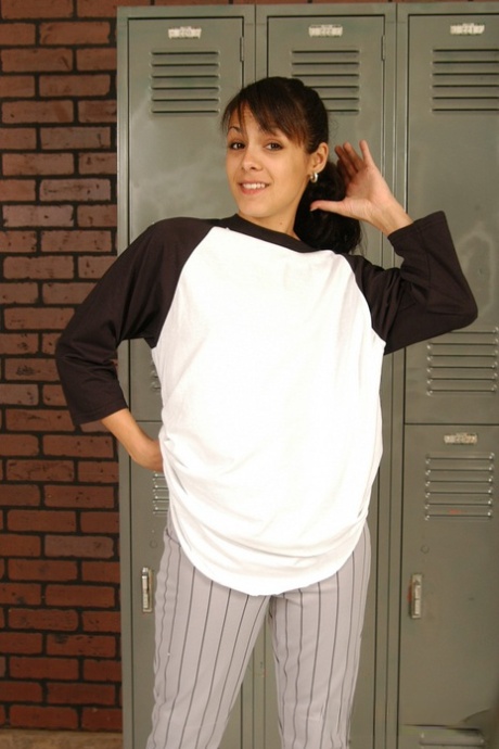 An adorable baseball player named Ana R takes off her clothes in the locker room and uses a bat to play with her toys.