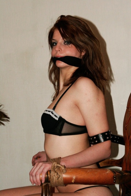 In seductive lingerie, Diana the slim brunette is gagged and tied up to a chair.