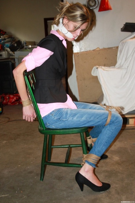 In the basement, Irena, a thin amateur blonde, is seen strapped to a chair.