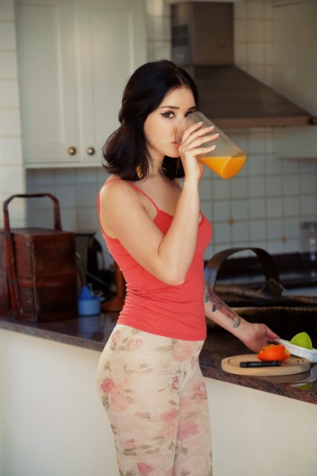 Malena, a brunette, strips and masturbates after having a fruit smoothie.