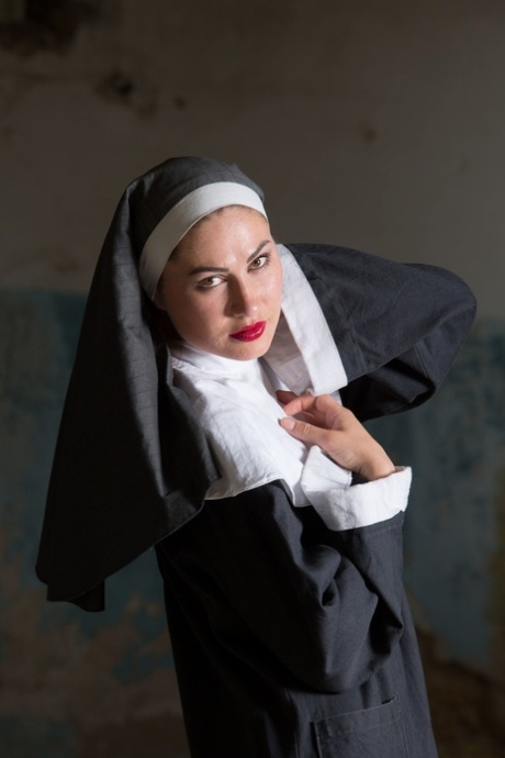 Judith Able, the Ukrainian nun, touches her pussy and juicy tits while undressing.