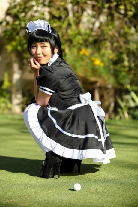 As she exits her uniform, Marica Hase, an Asian maid, displays her mouthful of muff in the open air.