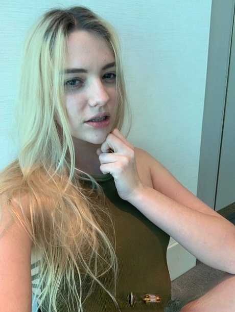 Blonde teen Kenna James strips her clothes and flaunts natural tits in a solo