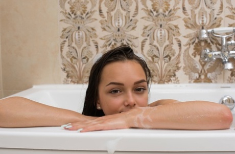 Sweet little girl Slava flaunts hot bodies in a bubble bath.