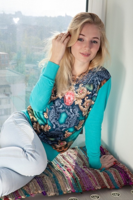 Petite Blonde Teen Leona Honey Uncovers Her Tasty Ass And Poses In The Window