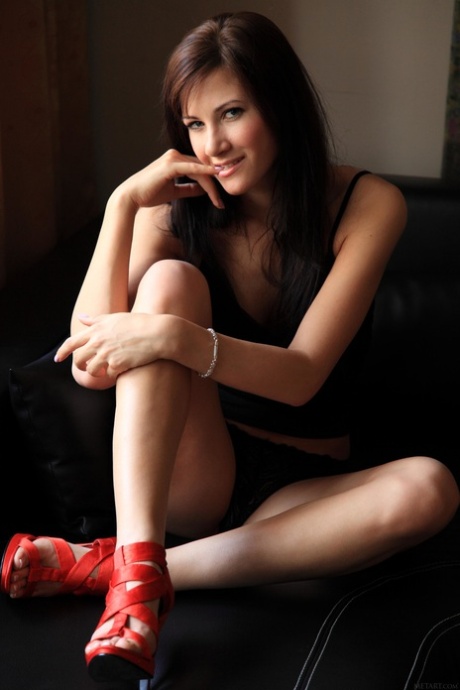 While posing in her black lingerie and red heels, Brunette model Lauren Crist showcases her wardrobe.