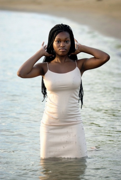 On the beach, Deserea A displays her juicy tits and showcases her African charm.