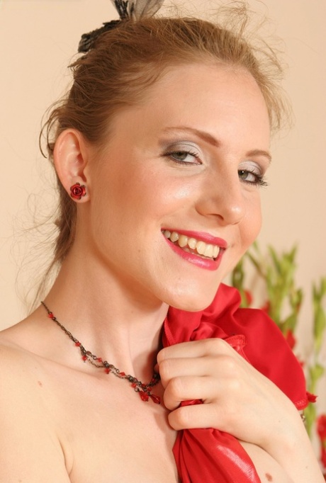 Lolly, a charming and dashing amateur, donnes her red dress while posing in lingerie.