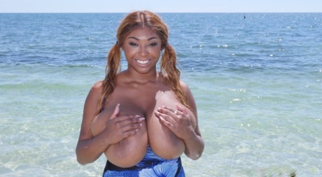Ebony with pigtailed cousin Rachel Raxxx, swimming and unleashing her massive tits in the ocean.