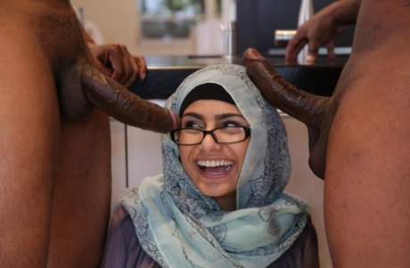 Geeky Lebanese pornstar Mia Khalifa performing a 3some with two big black penises.