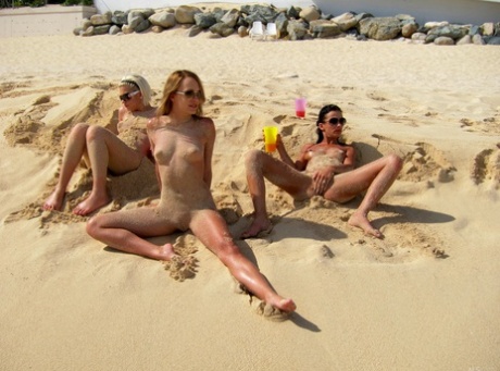 While at the beach, blonde lesbian Bibi Noel and her sexy girlfriends are naked and engaging in some fun.