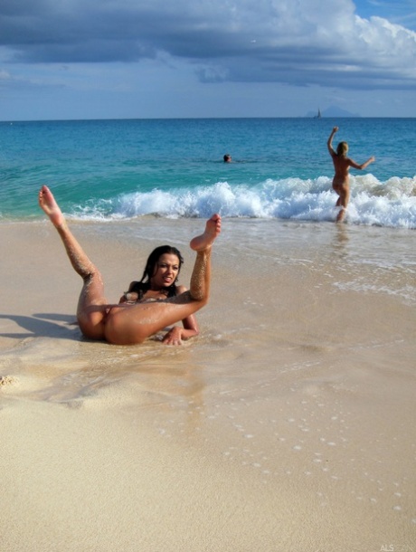 On a beachfront street, Bibi Noel and her girlfriends are naked, and they look gorgeous.