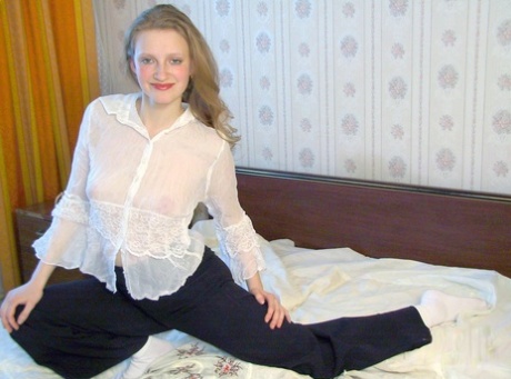 Amateur teen with tiny tits Lusya unveils her body and poses on a bed