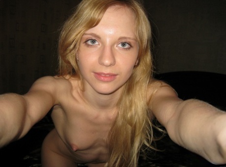 Stripped and naked: Cute blonde Christy films herself stripping while posing with her buttocks.