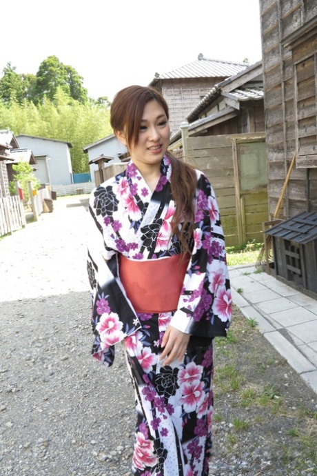 Asian brunette Maki Horiguchi, who is naked and cool, finishes her robe and enjoys eating a cock outside.
