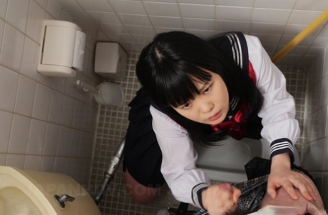 Sexy Japanese teen Sayaka Aishiro giving a gentle blowjob in a public toilet