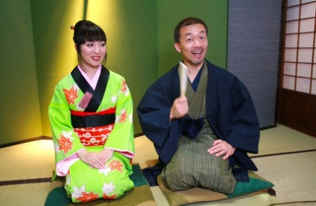 An Asian woman donning a green kimono gives a hairy cock in a POV style blowjob.
