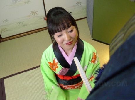 In front of me: A Japanese woman in a green kimono gives the hairy part of my lower lip a POV blowjob.