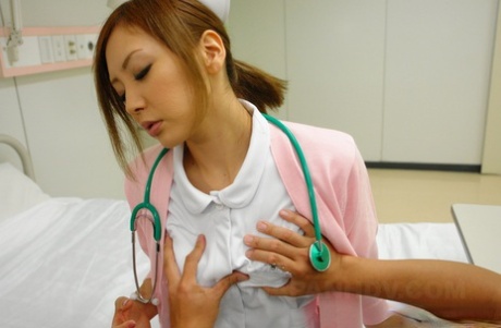 Charming Asian nurse Mio Kuraki takes off her uniform and masturbates - PornHugo.net