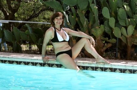 In the pool, a seductively mature Lynn displays her big breasts and masturbates.