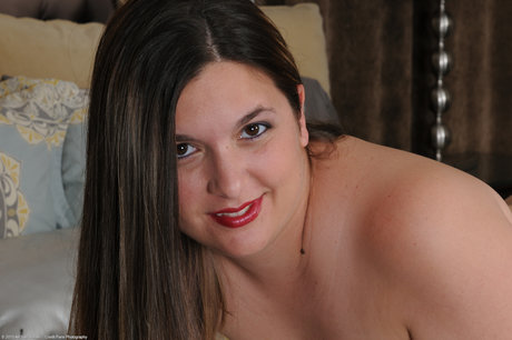 The naked body of Phoenix Wild, a full-figured brunette with freckles, is displayed.