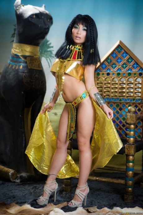 Dressed as Cleopatra, Rina Ellis from Petite Asia exposes her chest and buttocks.