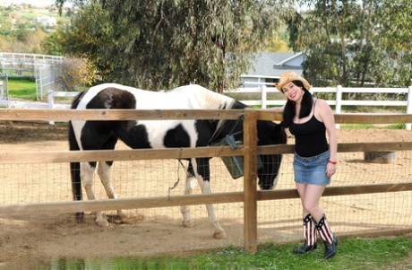 On the ranch, RayVeness - who is now an adult cowgirl -- strips and displays her large tits and asses.