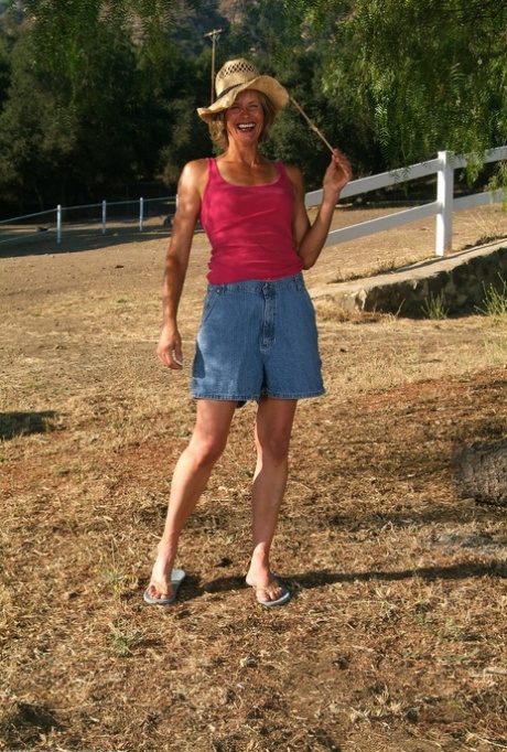 Skinny Mature Carmen F Loses Her Shirt And Denim Skirt To Pose Naked Outdoors