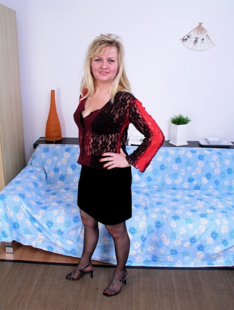 For her masturbation, the mature woman Carina strips herself to use her nylon stockings and heels.