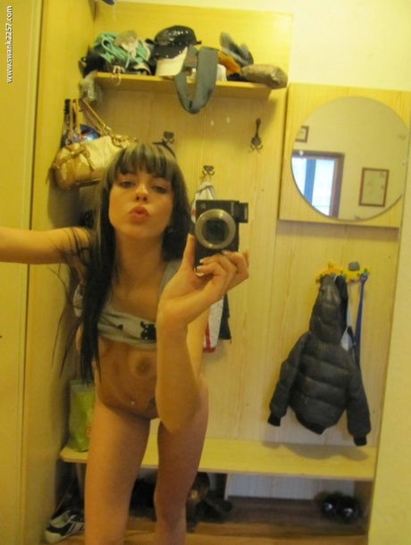 While filming herself in the mirror, amateur Mellie Swan displays her tits & twat while taking a picture.