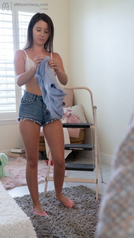 Teagan, a petite girl with a tattoo, wears a shirt and short jeans, along with a cute shirt.