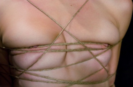 Her chest is tied up with a rope and vibrator by blonde girl, Tawni Ryden.