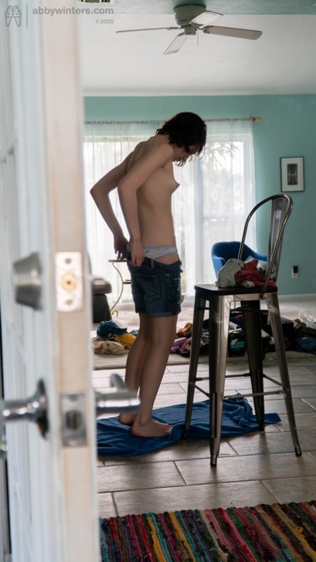 An amateur girl with black hair named Taylor M is dressed in tights, jeans, and a shirt.
