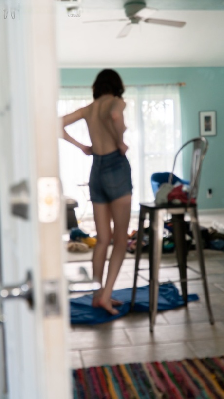 Taylor M, a black amateur girl, wears her jeans and tights over a shirt.