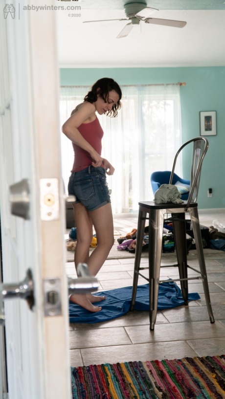 Taylor M, an amateur girl with black hair, wears a tight shirt and jeans, along with tights.