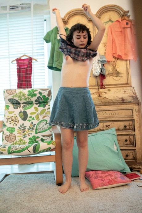 Klein amateur Kitty D appears nude while wearing a skirt with sequins on her forehead.