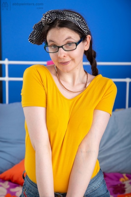 Nerdy amateur Tara J exhibits her bushy beaver while flaunting her naturals.