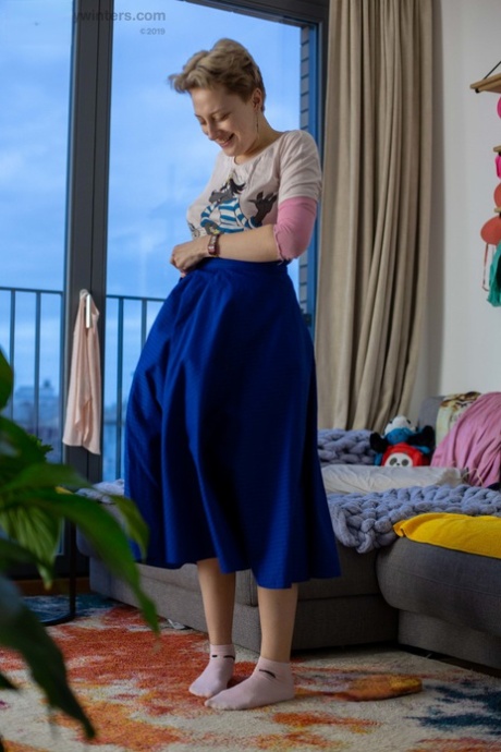Liza K's amateur blonde locks her hair in place of her own without any artificial modifications while getting dressed.